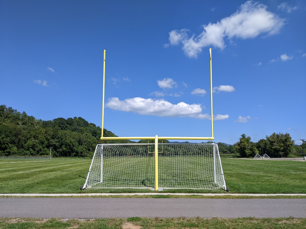 A view of the multipurpose field shows soccer and football goals on a sunny summer day.