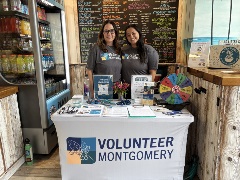 Two women tabling at Playa Bowls.